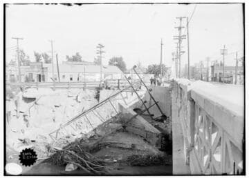 Kern River & Borel Transmission Line - Three boys and two women with baby carriage looking at a fallen tower, resulting from storm of February 20, 1914. This is the north view, and in the background is the Price-Corcoran