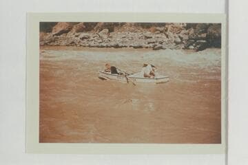 Dropping down the eddy below Vulcan Rapid after lining the Nevills sadirons. Nevills scrambles to close the hatch. Joe Desloge and Margaret Marston sit on the stern