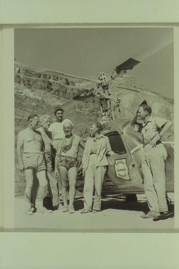 Boat party and pilot posed with helicopter; Tapeats Creek. Left to right: Taylor, Desloge, Forcier, Marston, Margaret Marston and Carson
