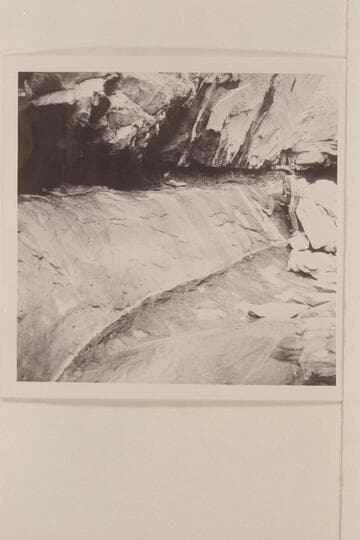 Red stains on rock at spring in Black Water Creek; North side of Navajo Mountain. Black Water Cave
