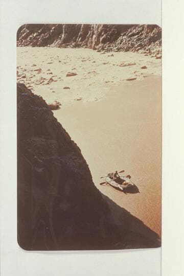 Sockdologer Rapids, Colorado River. Inspecting rapids in small black boat