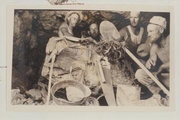 Cache which Frederick T. Barry claimed his party left at the cave at Cave Springs Rapid in 1888 and which was found by the USGS party Aug. 6, 1923. Emery Kolb and Raymond Moore at the back. Frank Dodge at right and Frank Word is next to him