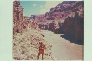 Little John photographing the area where the Dead Man lies above Paradise Canyon. Boats in background. Preliminary Lees Ferry gauge: 122,000 cfs