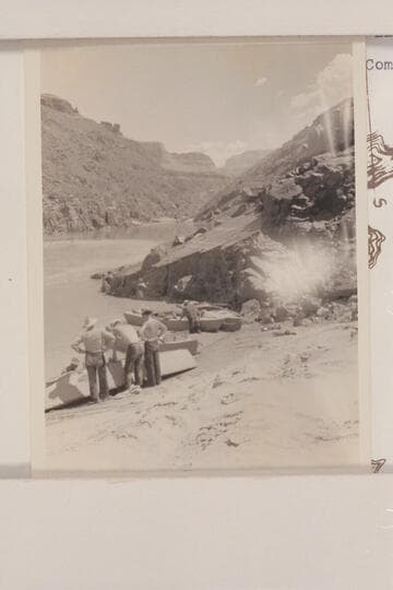 Upriver at head of Serpentine Rapid. Mile 105.95. Bright Angel gauge: 2650 cfs. Eddy lost 12 films of the 4x5 size covering Serpentine to camp below Elves Chasm. This may be Eddy's photo 17-2, captioned "Repairing boat."