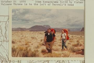 Mac Terrell and Bill Mooz hiking down Prospect Valley to the rim prior to starting a float down Grand Canyon to Lake Mead. Vulcan's Throne is to the left of Terrell's head