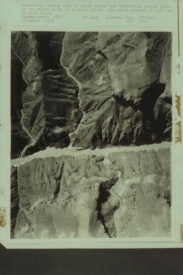 Serpentine Canyon left of upper center and Serpentine Canyon Rapid at its mouth which is at Mile 105.9. The cross canyons at left are at Mile 105.6