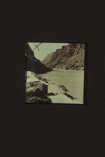 Down river from the cove above Bridge Canyon Rapid, Mile 234.9. Jim Jordan and the "JUNE BUG" at the beach