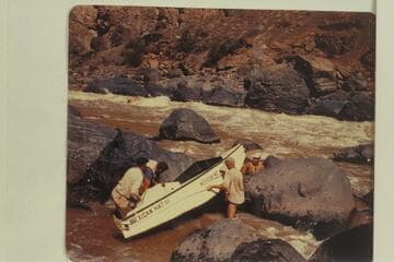 Lining of the "Mexican Hat III"--or is it a portage? Frank Wright; John Harper; Bill Thompson; Willard Wright. No life preserver protection for the leader and others. Georgie White ran her party through the rapid at this same time