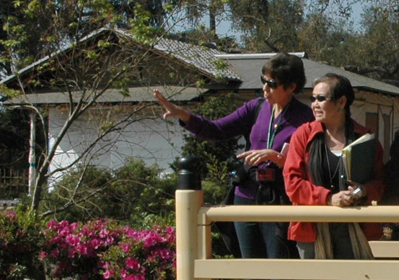 Nino Wong (right) and fellow docent Susan Harbach admire the view from the top of the waterfall. Nino Wong (right) and fellow docent Susan Harbach admire the view from the top of the waterfall.